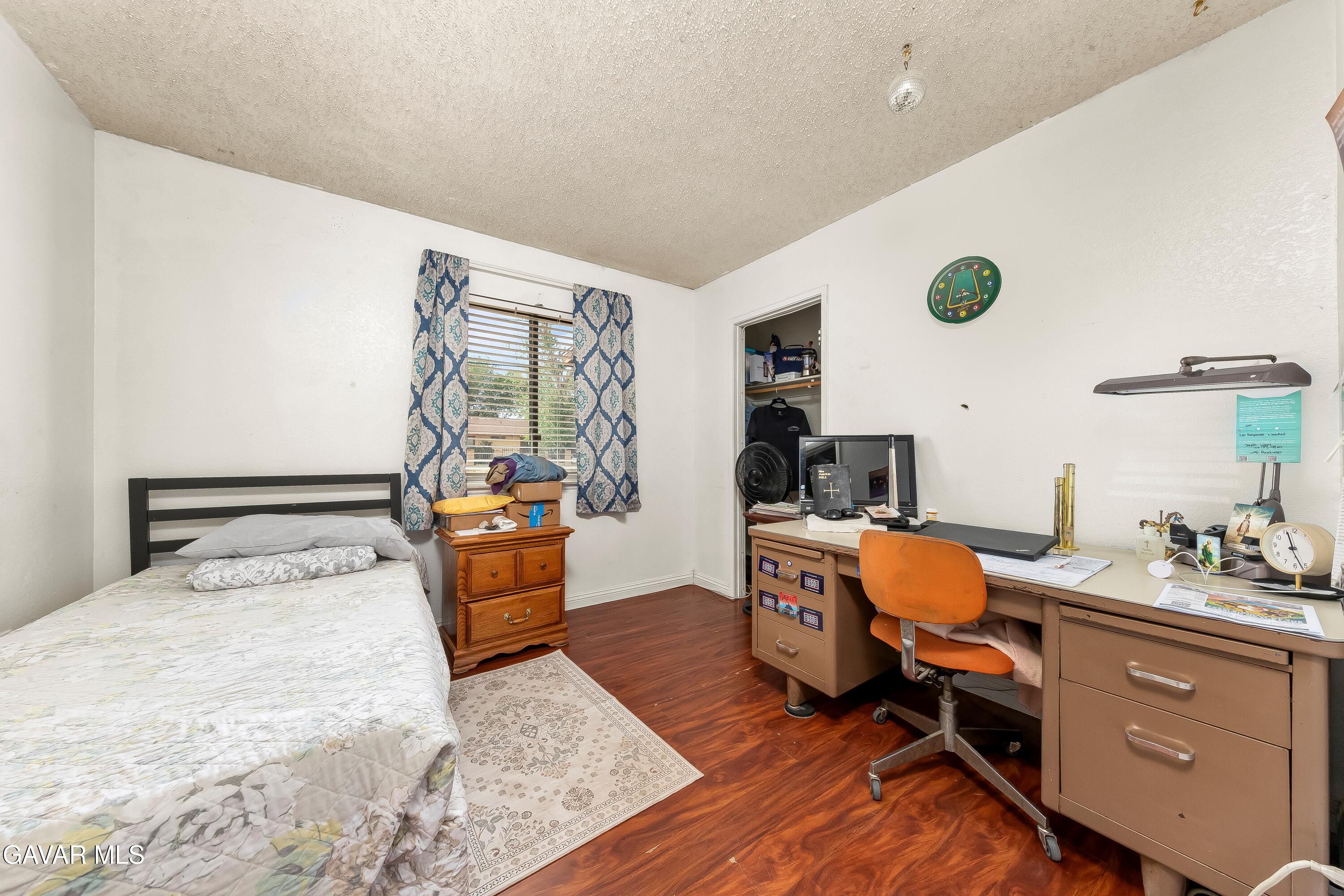 10731 East Ave R-2 Littlerock, CA 93543 - Photo 11 of 23 a bed room with a bed and a chair