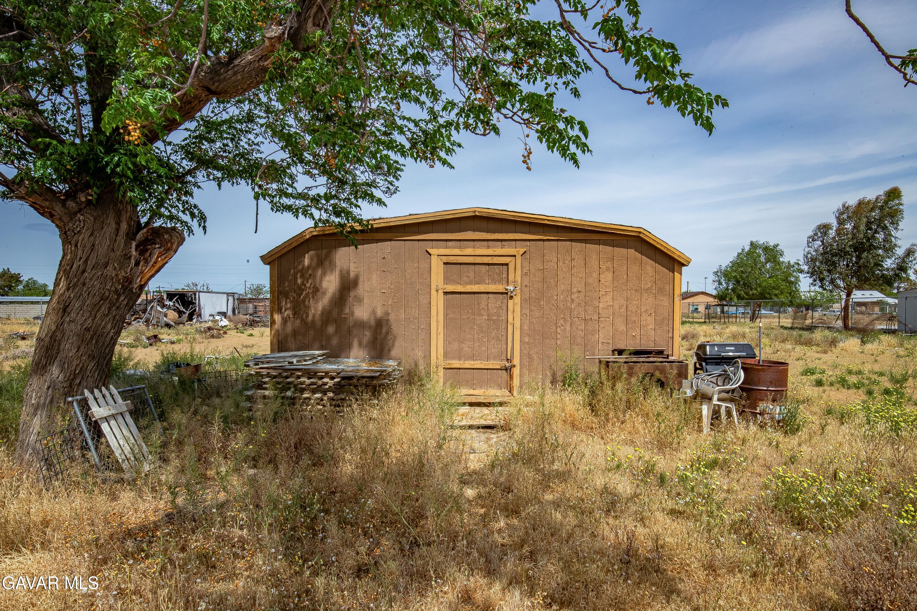 10731 East Ave R-2 Littlerock, CA 93543 - Photo 15 of 23 a backyard of a house with table and chairs