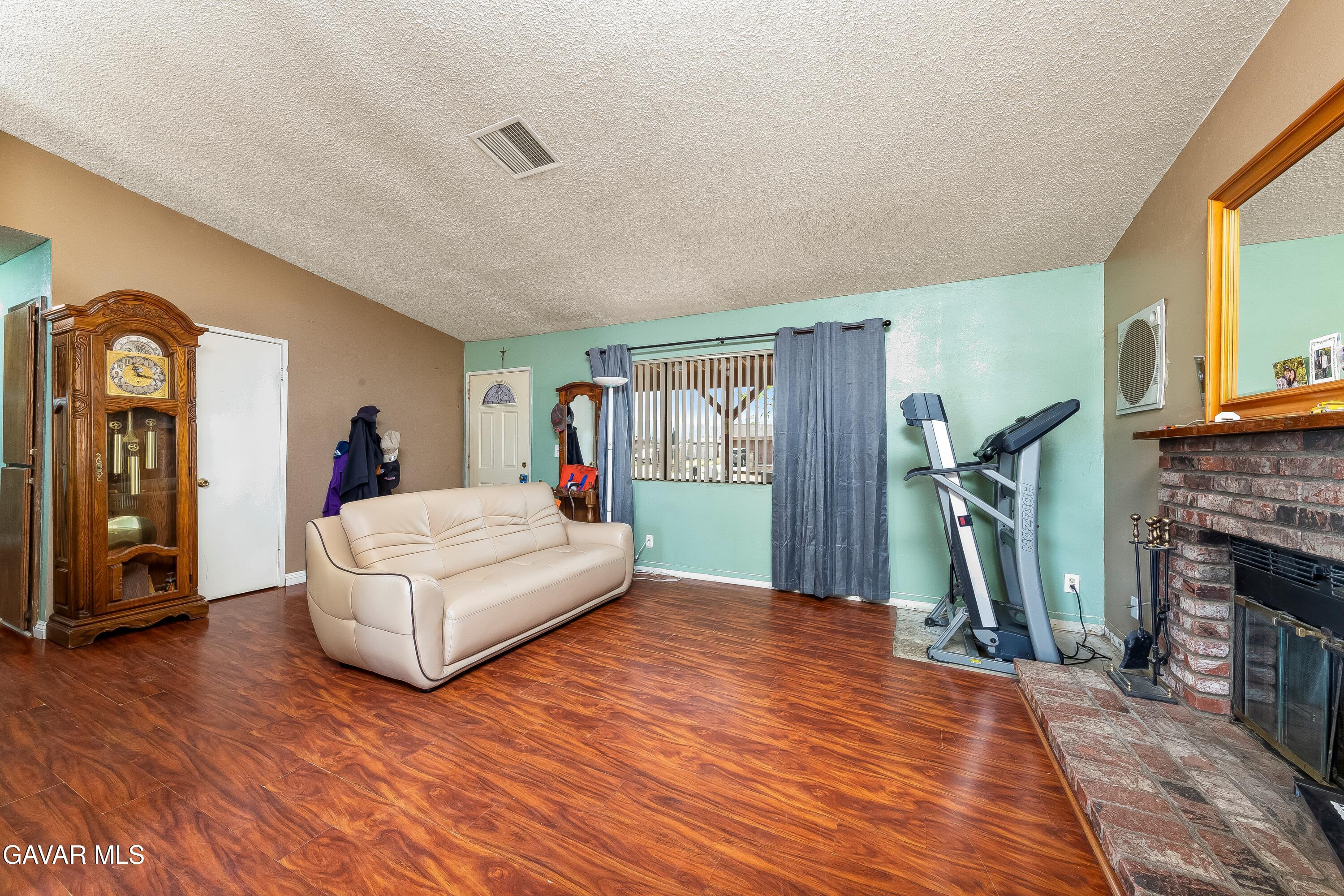 10731 East Ave R-2 Littlerock, CA 93543 - Photo 3 of 23 a bedroom with a bed and a flat screen tv