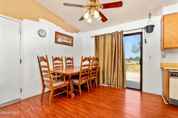 a dining room with furniture wooden floor a rug and a chandelier
