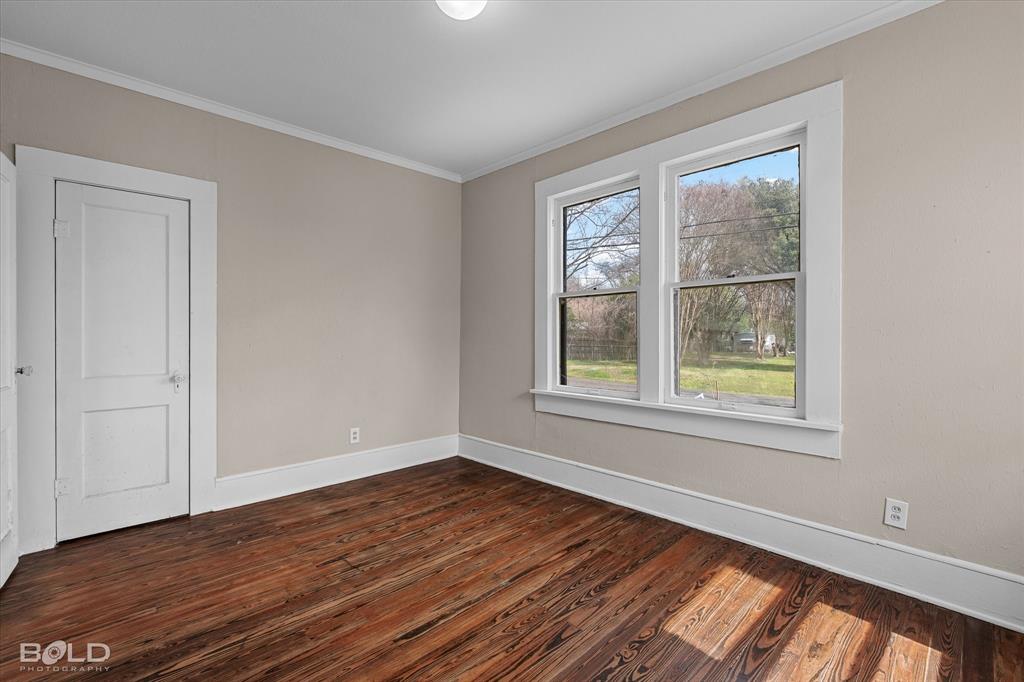 323 Butler Road Belcher, LA 71004 - Photo 11 of 28 a view of an empty room with wooden floor and a window