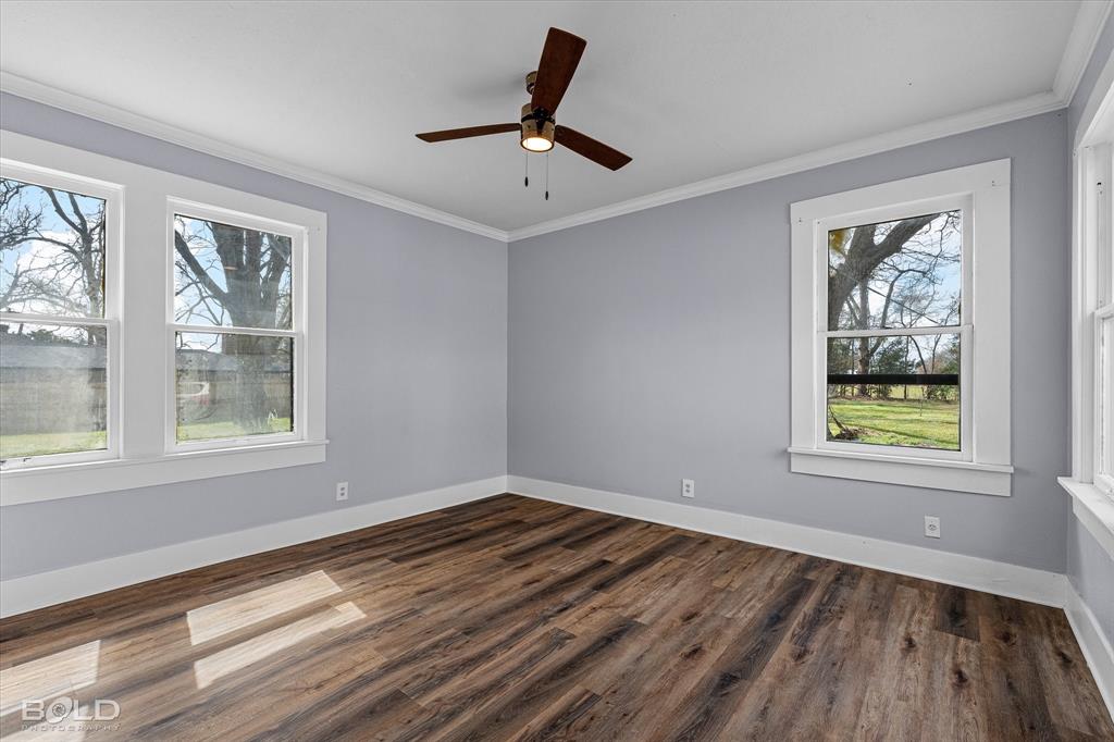 323 Butler Road Belcher, LA 71004 - Photo 20 of 28 a view of an empty room with wooden floor and a window
