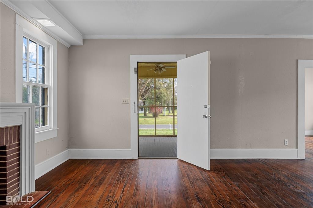323 Butler Road Belcher, LA 71004 - Photo 4 of 28 an empty room with wooden floor and windows