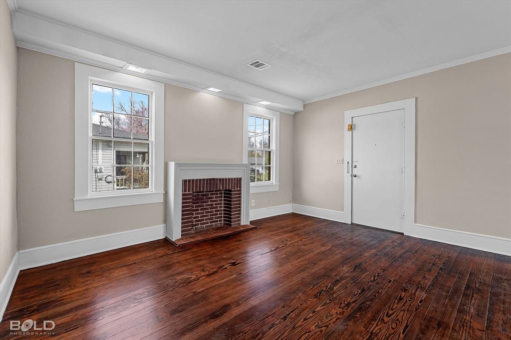 323 Butler Road Belcher, LA 71004 - Photo 5 of 28 a view of an empty room with wooden floor and a window