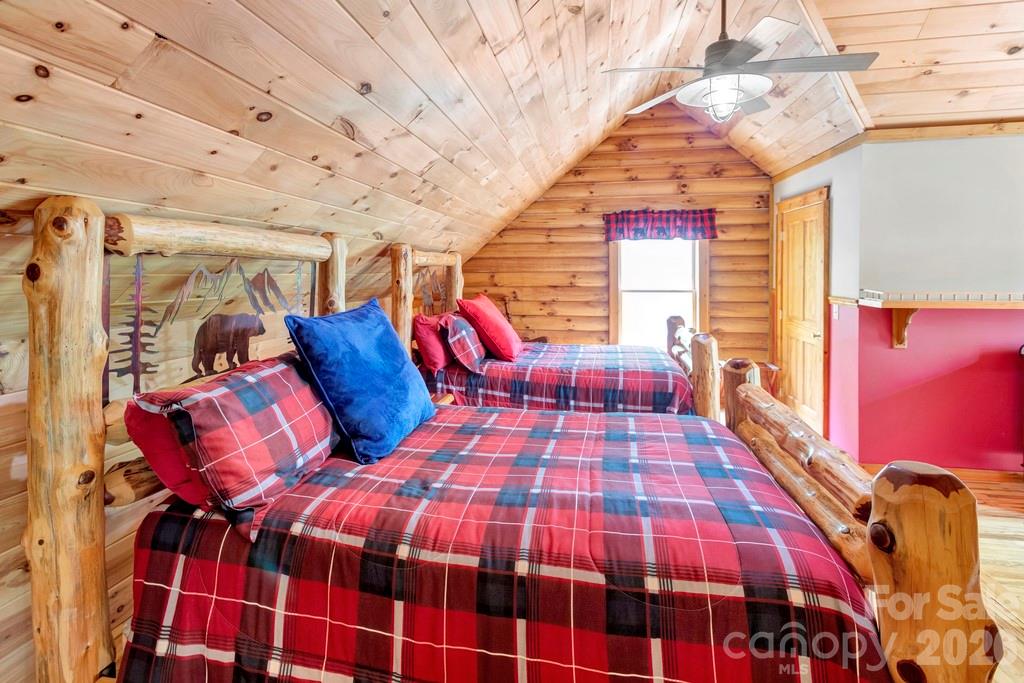35 Falcon Crest Loop Maggie Valley, NC 28751 - Photo 25 of 46 a bedroom with a bed and wooden floor