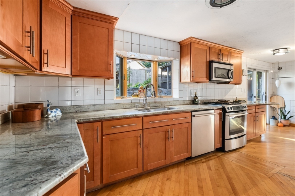75 Bay View Drive Swampscott, MA 01907 - Photo 11 of 41 a kitchen with stainless steel appliances granite countertop a stove a sink and a microwave