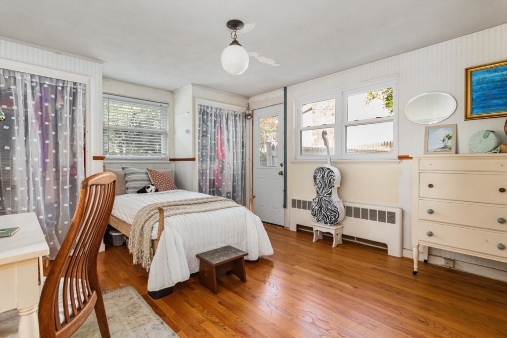 75 Bay View Drive Swampscott, MA 01907 - Photo 17 of 41 a bedroom with a bed and wooden floor