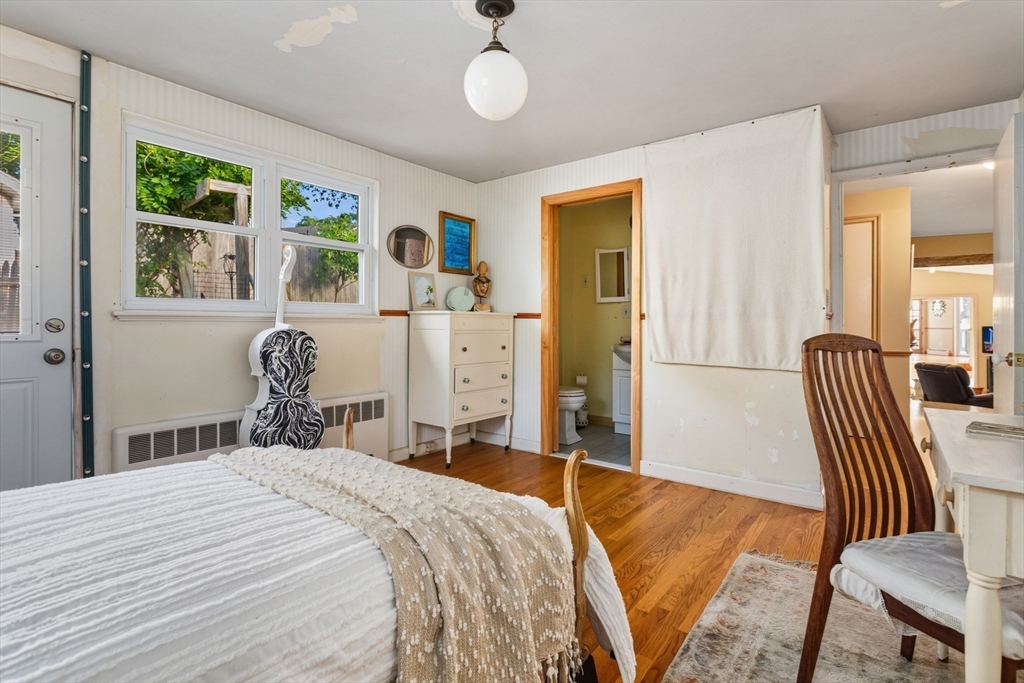 75 Bay View Drive Swampscott, MA 01907 - Photo 18 of 41 a bedroom with a bed and wooden floor