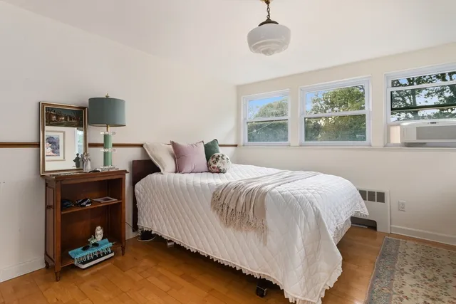 a bedroom with a bed and a window