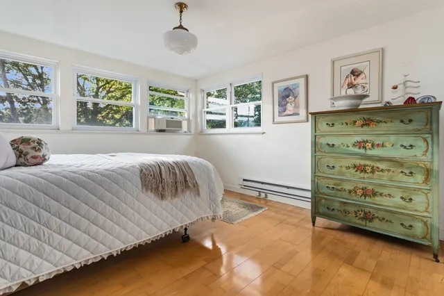 a bedroom with a large bed and a window
