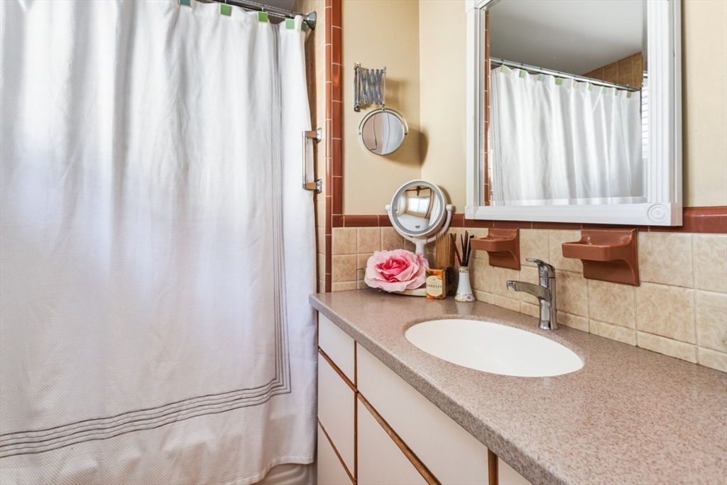 75 Bay View Drive Swampscott, MA 01907 - Photo 27 of 41 a bathroom with a granite countertop sink and a mirror
