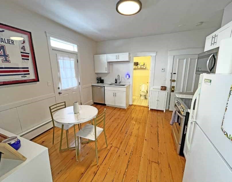 52 North Main Street Natick, MA 01760 - Photo 11 of 25 a view of a dining room with furniture and wooden floor
