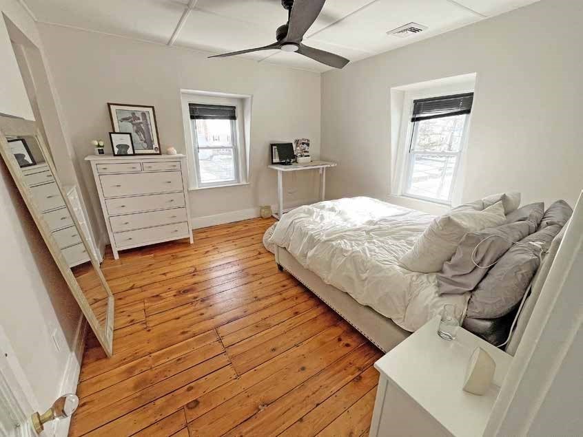 52 North Main Street Natick, MA 01760 - Photo 12 of 25 a bedroom with a bed and wooden floor