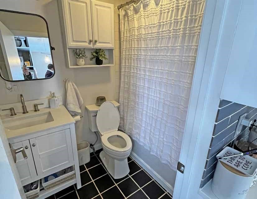52 North Main Street Natick, MA 01760 - Photo 13 of 25 a bathroom with a toilet a sink and a mirror