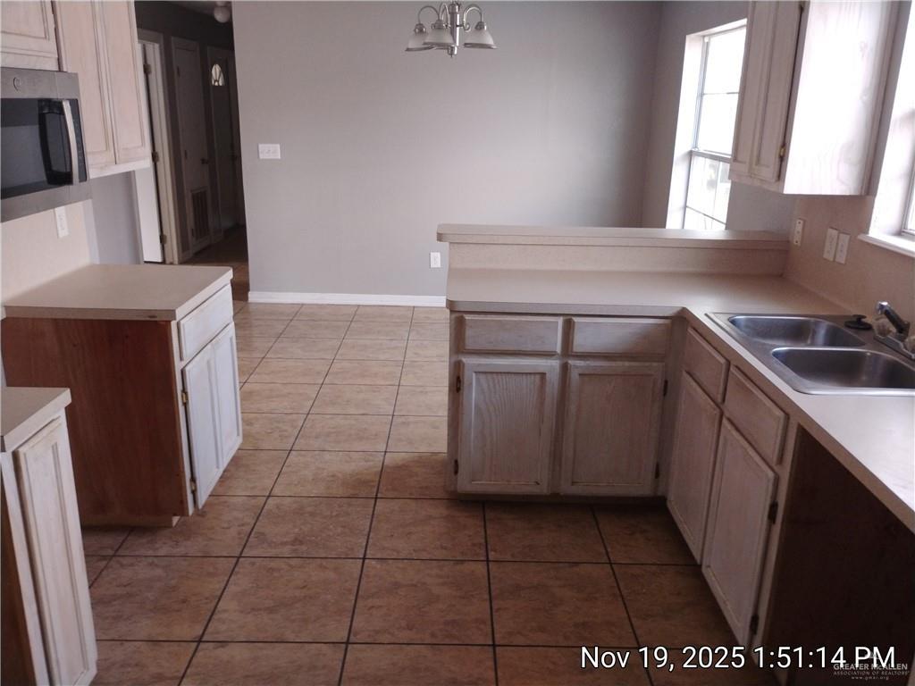 2031 Lake View Drive Mission, TX 78572 - Photo 5 of 13 a kitchen with a sink a stove and cabinets