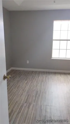 a view of hallway with wooden floor