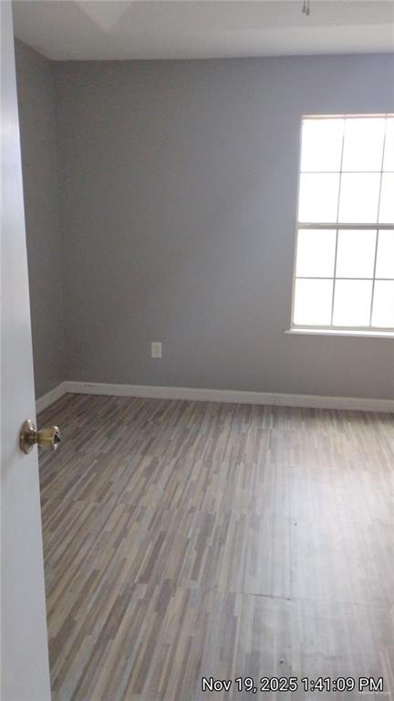 2031 Lake View Drive Mission, TX 78572 - Photo 9 of 13 an empty room with wooden floor and windows