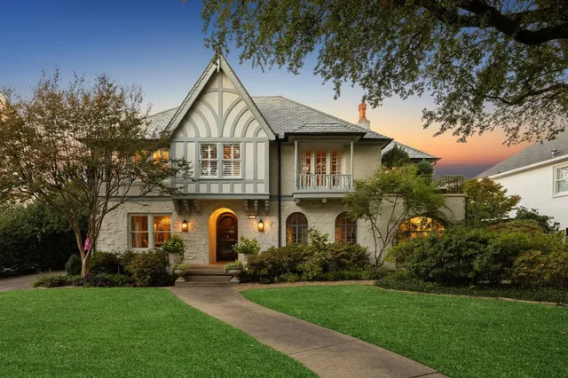 a front view of a house with a garden and plants