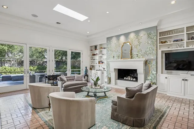 a living room with furniture a flat screen tv and a fireplace