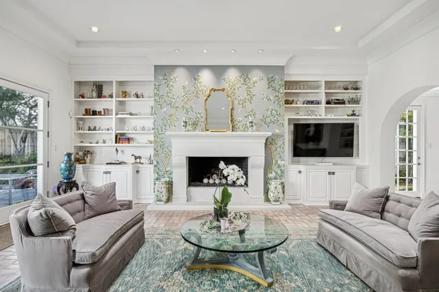 a living room with furniture a fireplace and a flat screen tv