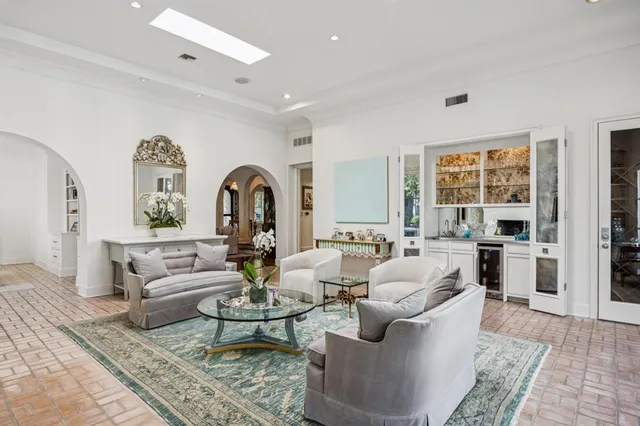 a living room with fireplace furniture and a large window
