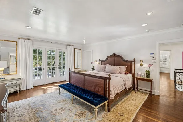 a spacious bedroom with a bed couch and a window