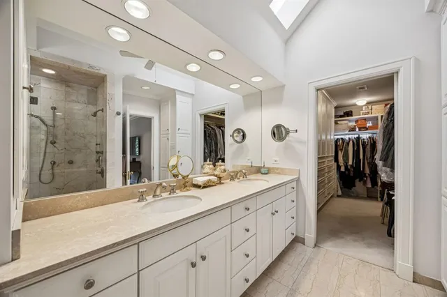 a spacious bathroom with a granite countertop sink mirror and shower