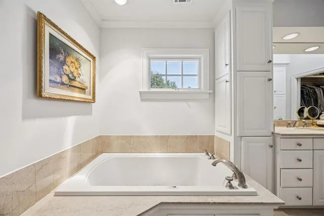 a bathroom with bathtub and window