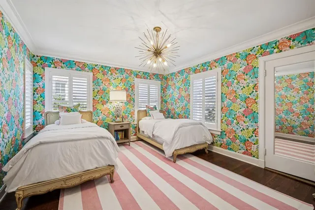 a bedroom with a bed table and a window