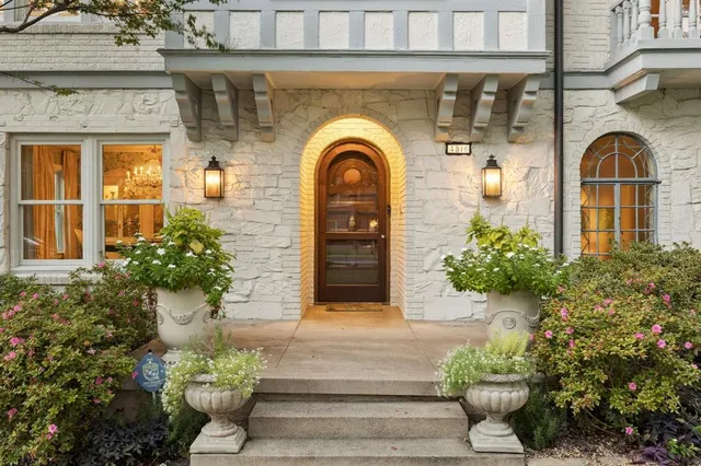 a front view of a house with potted plants