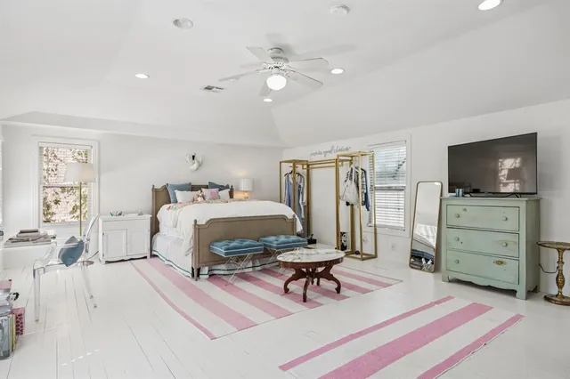 a bedroom with furniture and a flat screen tv