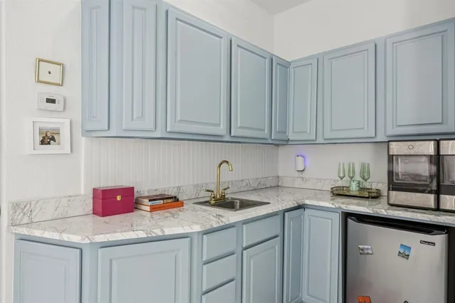 a kitchen with stainless steel appliances granite countertop a sink dishwasher and cabinets with wooden floor