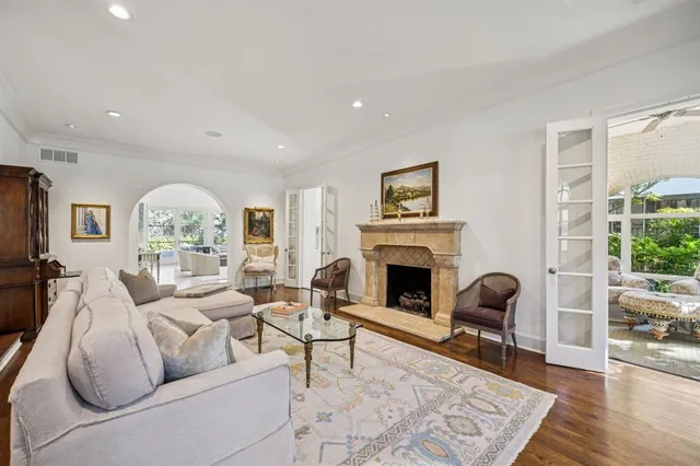 a living room with furniture fireplace and a large window