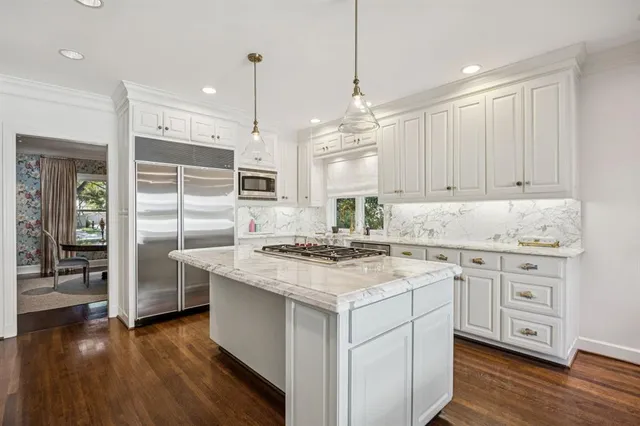 a kitchen with a stove a sink and a refrigerator