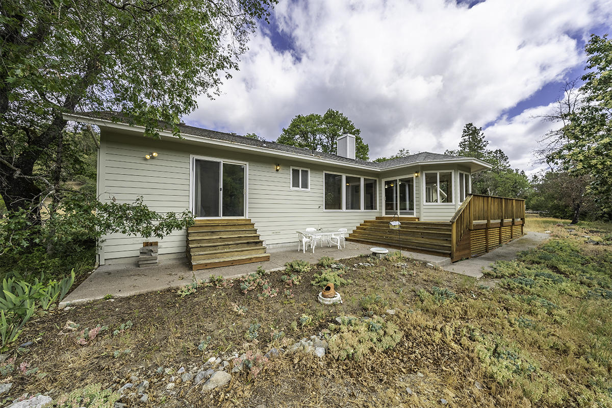 7255-7277 Upper Applegate Road Jacksonville, OR 97530 - Photo 27 of 36 a view of a house with backyard and trees