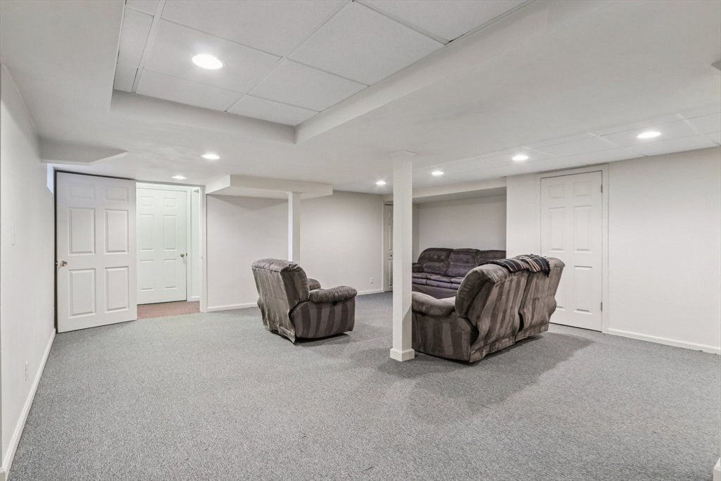 11 Thaxton Road Beverly, MA 01915 - Photo 31 of 40 a living room with furniture a couch and kitchen view