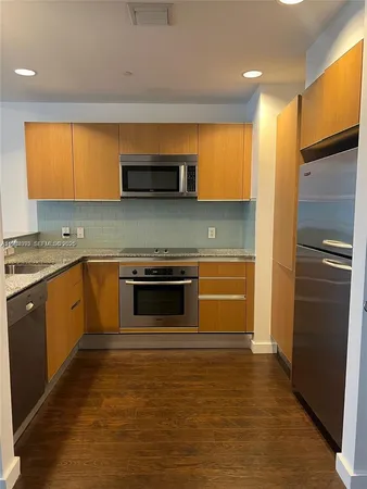 a kitchen with stainless steel appliances a stove and a refrigerator