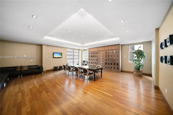 a living room with furniture pool table and windows