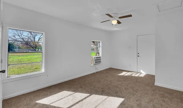 a view of an empty room with a window