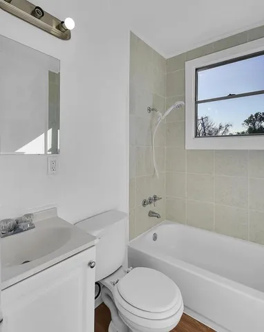 a bathroom with a sink a toilet and bathtub