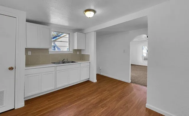 a kitchen with sink and cabinets