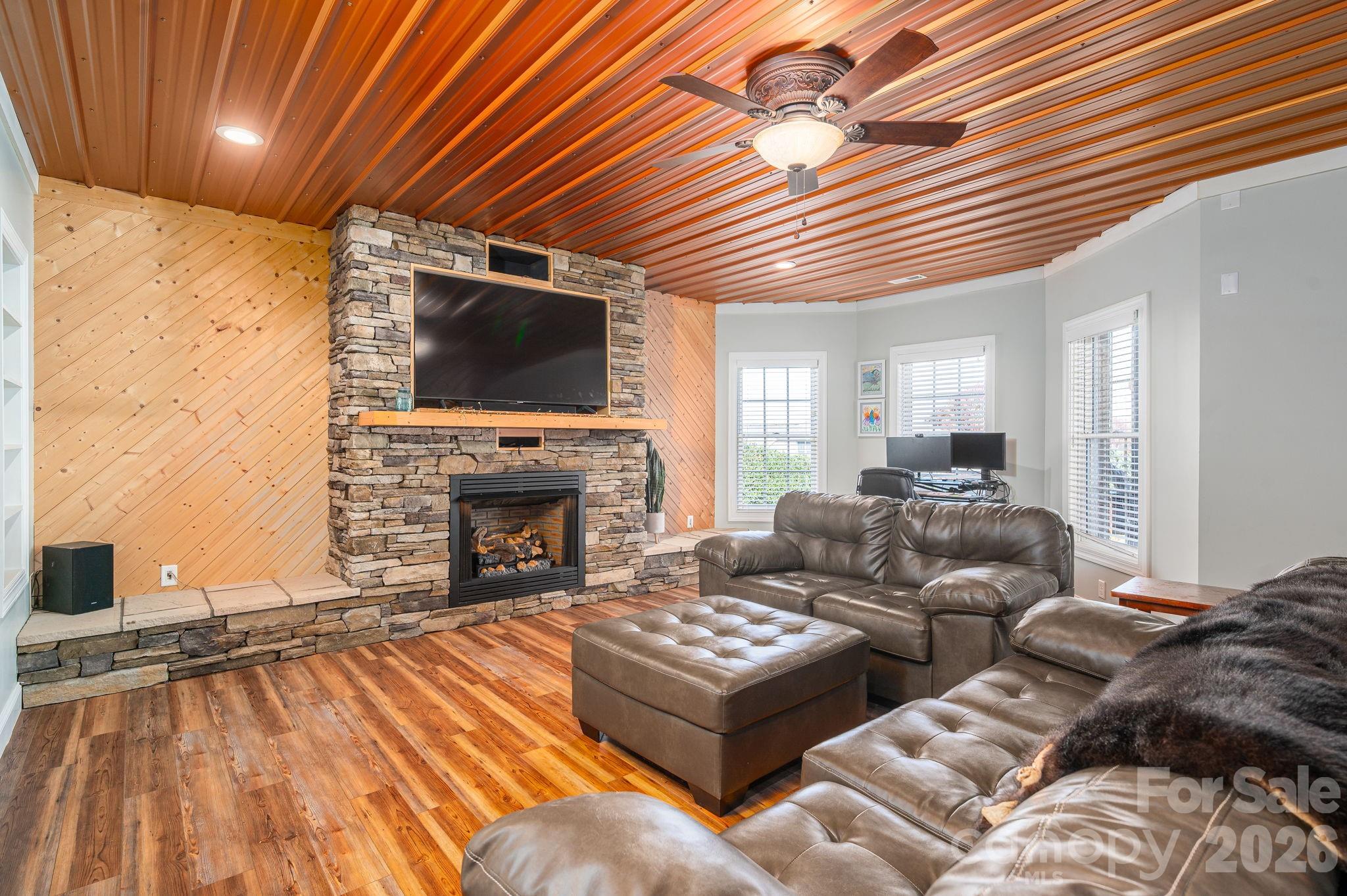 2616 Nicklaus Court Conover, NC 28613 - Photo 23 of 48 a living room with furniture a flat screen tv and a fireplace