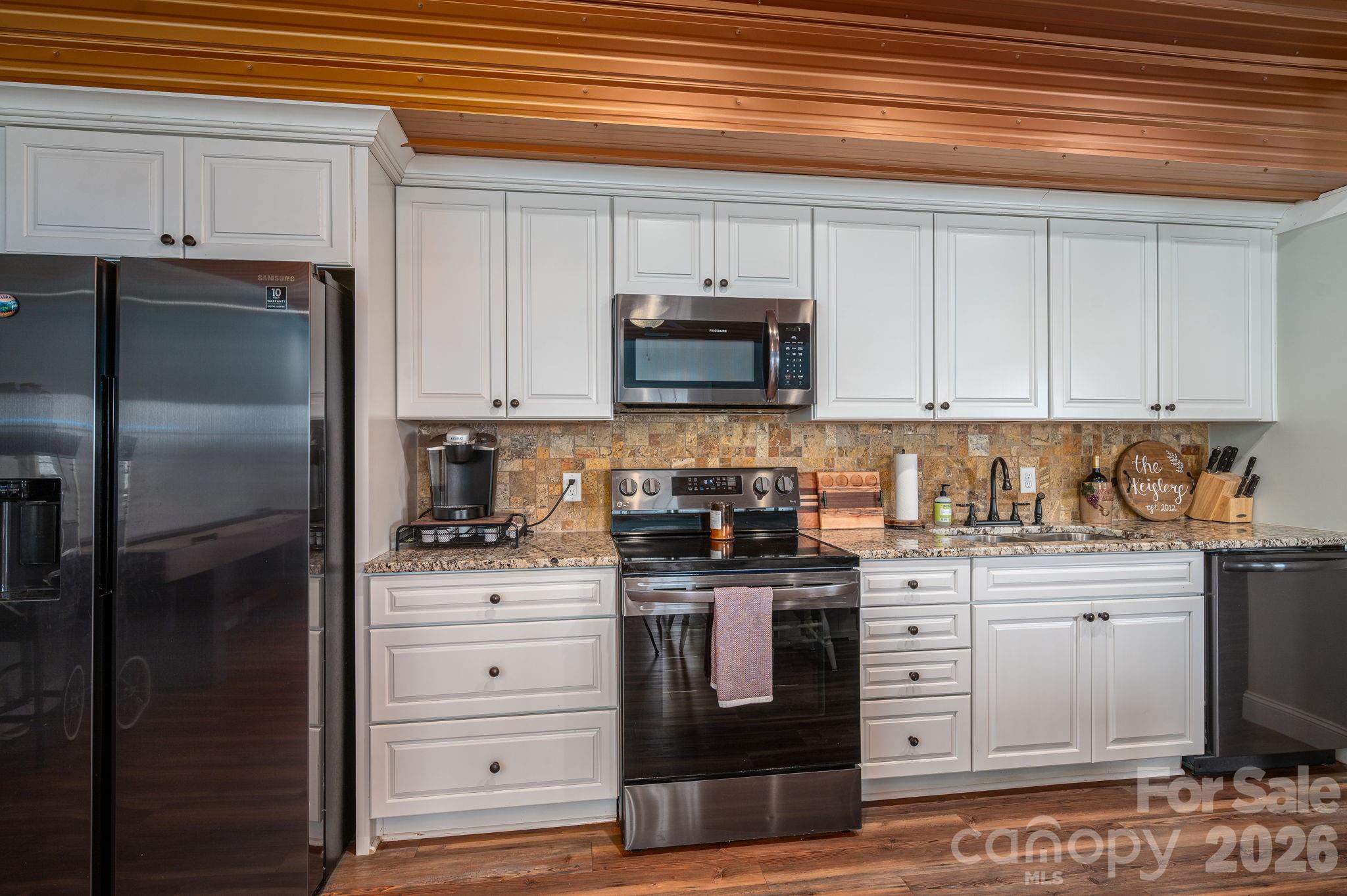 2616 Nicklaus Court Conover, NC 28613 - Photo 26 of 48 a kitchen with stainless steel appliances granite countertop a refrigerator and a stove
