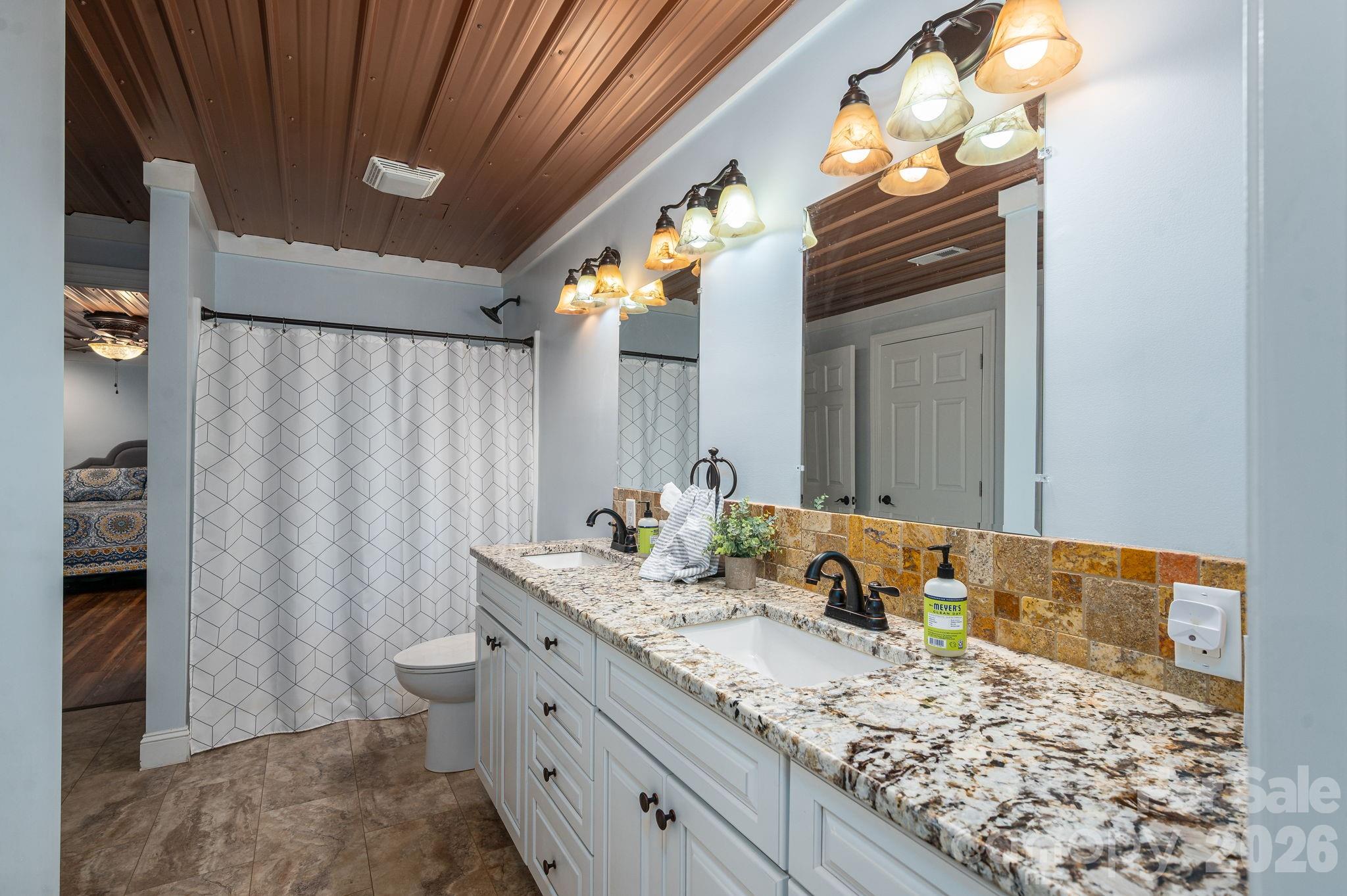 2616 Nicklaus Court Conover, NC 28613 - Photo 30 of 48 a bathroom with a granite countertop sink and a mirror