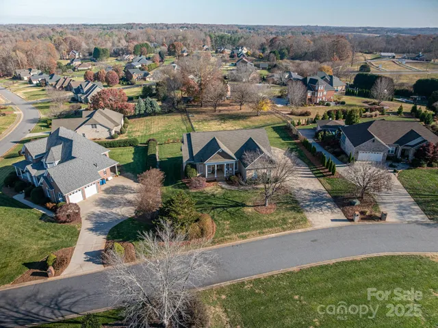an aerial view of a houses with yard
