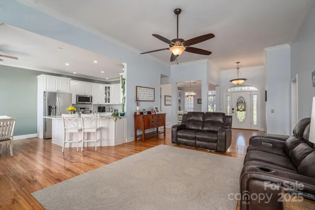 a view of a dining room with furniture and chandelier