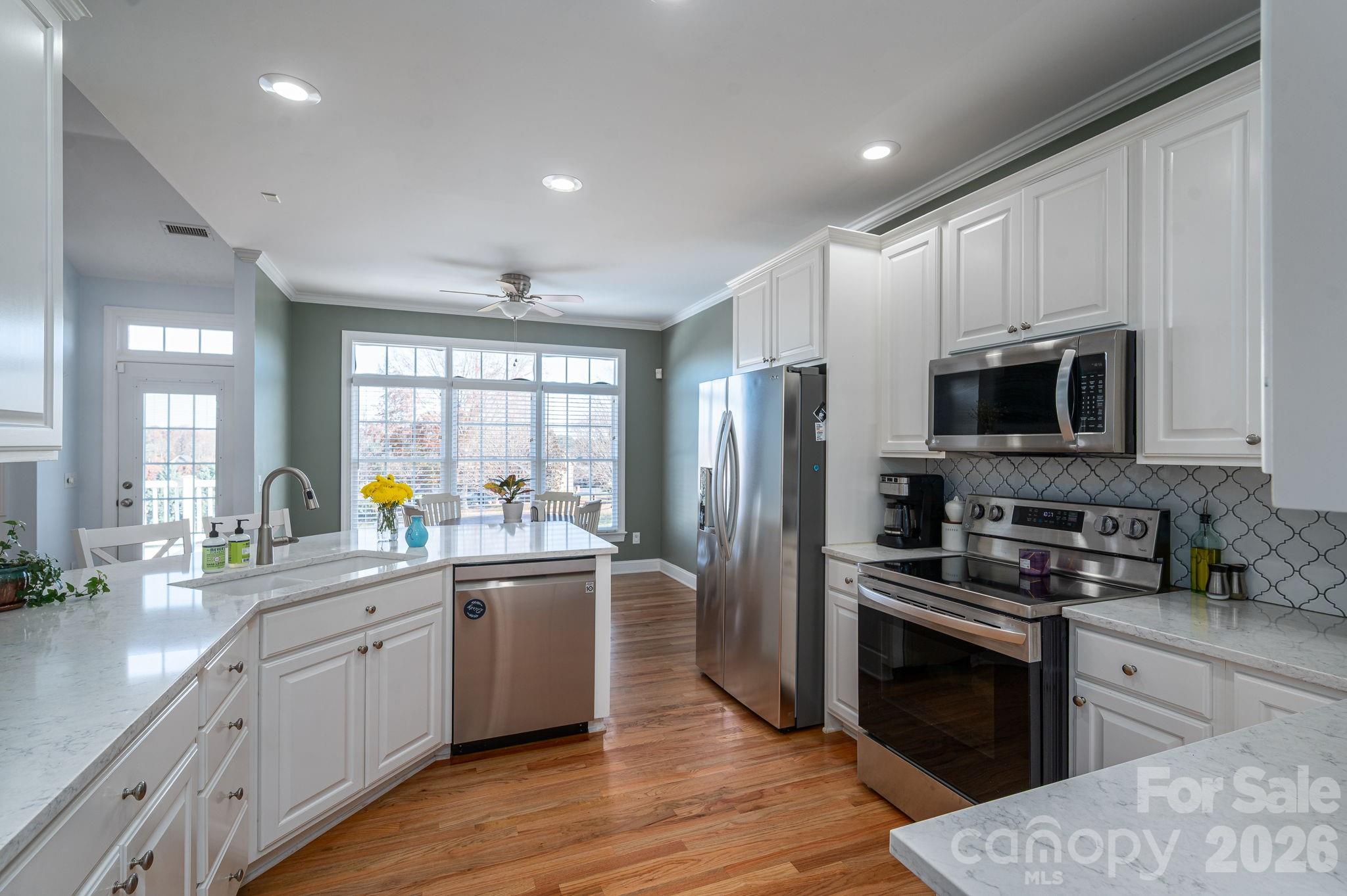 2616 Nicklaus Court Conover, NC 28613 - Photo 9 of 48 a kitchen with stainless steel appliances a microwave a sink and a refrigerator