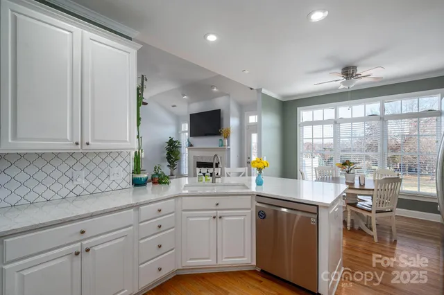 a dining room with furniture window and wooden floor