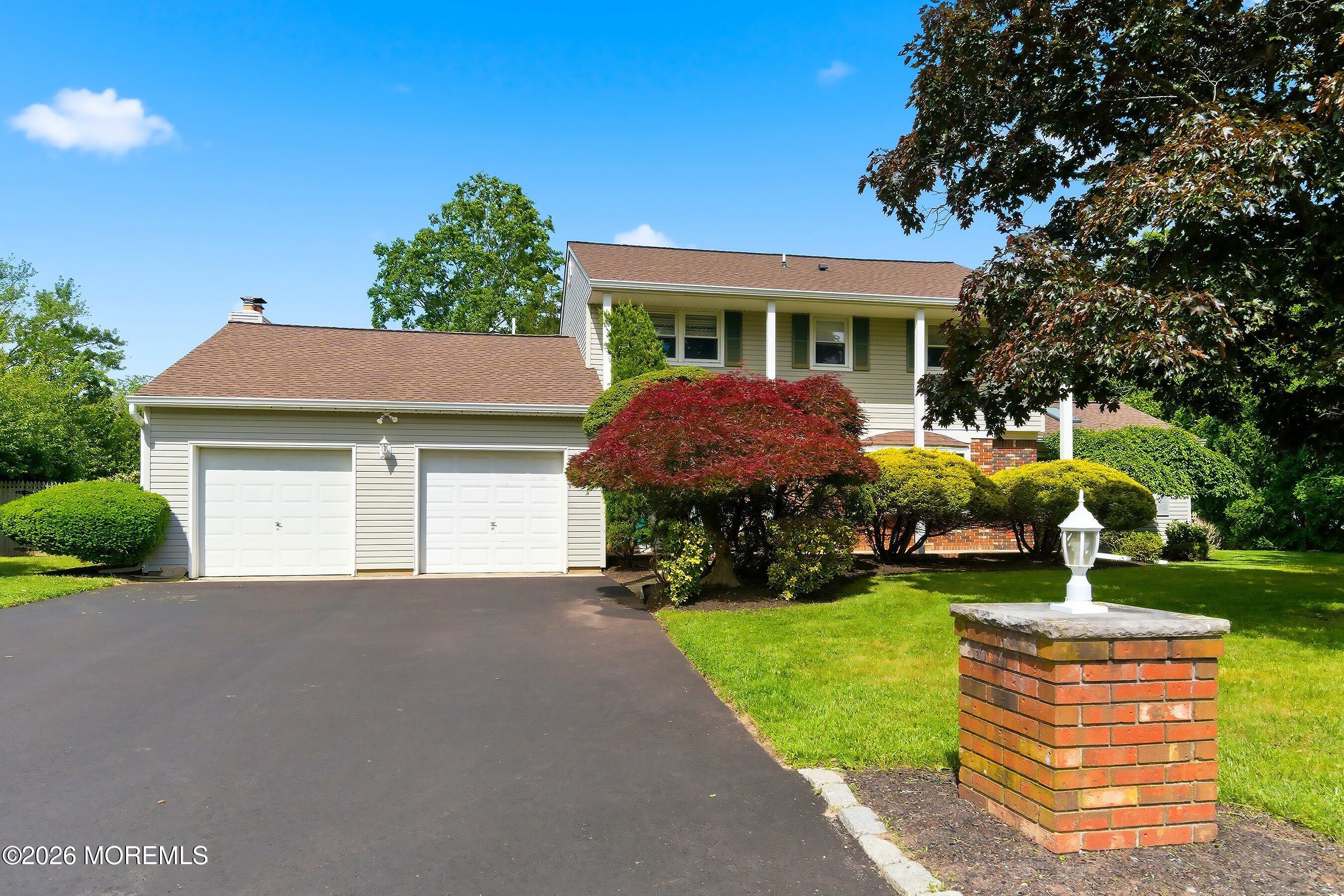 a front view of house with yard and green space
