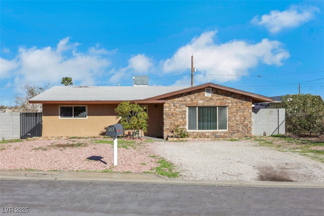 Single story home featuring stucco siding and stone siding